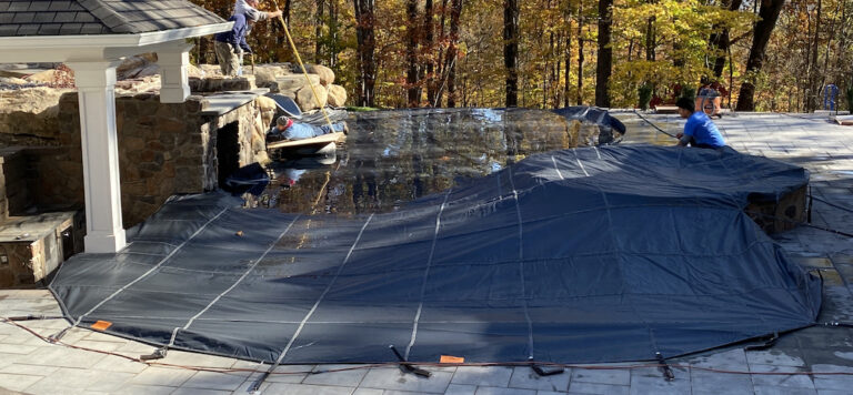 people removing a pool cover